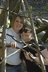  photo of two women in a tent of sticks 