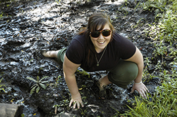 photo of woman posing on muddy ground