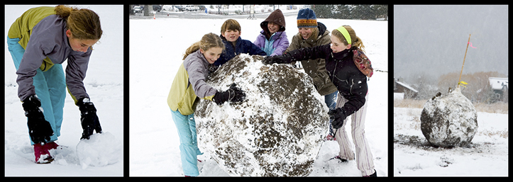 5 artists in the snow making a big snowball sculpture